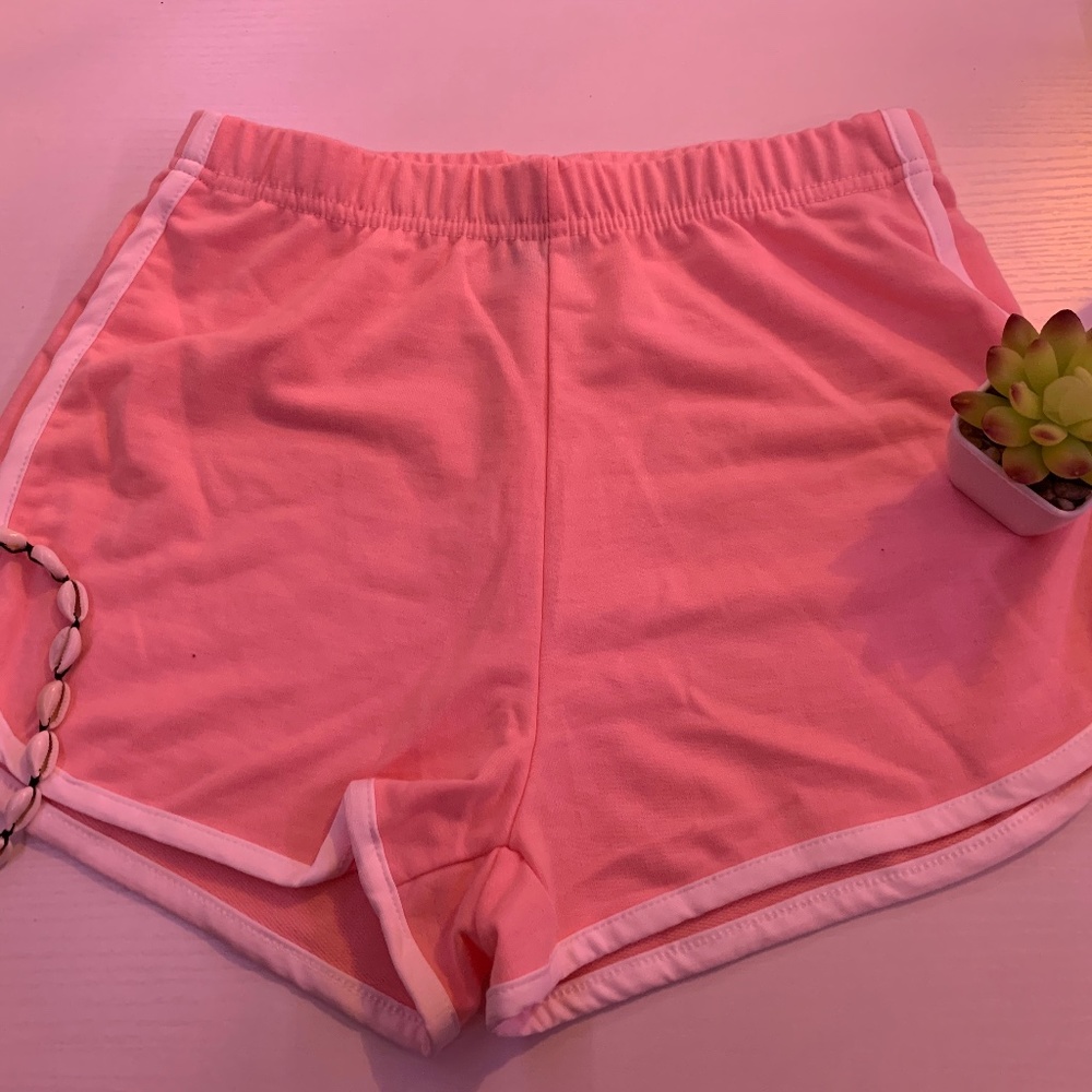 Light pink shorts with a white outline with a stretchy waistband super comfy and